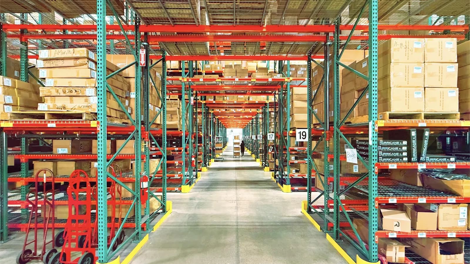 Warehouse aisle of racked office and facility supplies