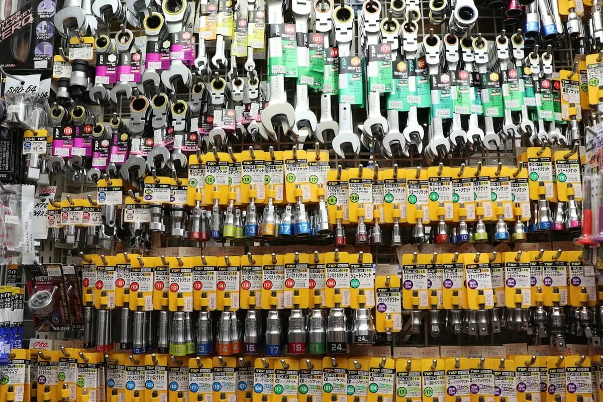 A supplier wall of maintenance stock: spanners, fittings and electrical consumables